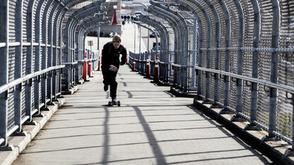 A skateboarder accelerates up the 10th Street pedestrian bridge. The walkway will be closed for a maintenance project on Feb. 20.