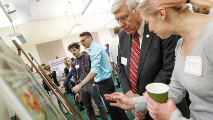 Catherine Berrick (right) explains her research on bats to Nebraska Sen. Robert Hilkemann during the 2017 Spring Research Fair breakfast and poster presentation at the State Capitol building. Students will interact with senators as part of the 2018 fair on April 10. 