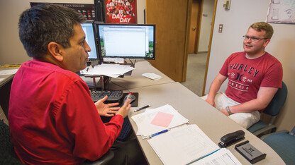 Ryan Green (right) meets with Juan Gutierrez, assistant registrar, on Aug. 30. Green received deployment orders on Aug. 30 and had a handful to days to prepare for departure.