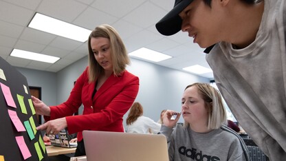 UNL professor interacting with students on a sustainability project