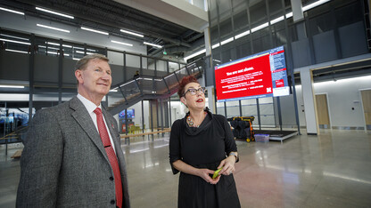 Ted Carter listens as Megan Elliott, founding director of the Johnny Carson Center for Emerging Media Arts, describes the technology available in the new center.