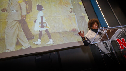With Norman Rockwell's "The Problem We All Live With" in the background, civil rights icon Ruby Bridges delivers the MLK Week address on Jan. 22 in the Willa Cather Dining Center's Red Cloud Room. More than 275 attended the event. The painting depicts Bridges as she is led by U.S. Marshals into an all-white New Orleans school.