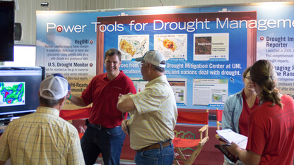 Brian Fuchs, a National Drought Mitigation Center climatologist and U.S. Drought Monitor author, discusses the prospects for rain with visitors to Husker Harvest Days, an agriculture trade show held each September in Grand Island.