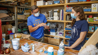 Eddie Dominguez, professor of art, works with UCARE student Kinga Aletto in August 2020. 