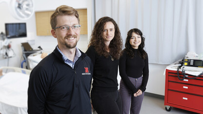 Husker researchers Arthur "Trey" Andrews, Tierney Lorenz and Sara Reyes pose in a patient room.