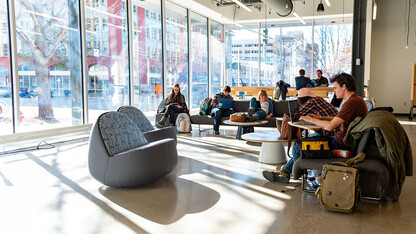 Students lounge in the Johnny Carson Center for Emerging Media Arts as sunlight streams through the windows