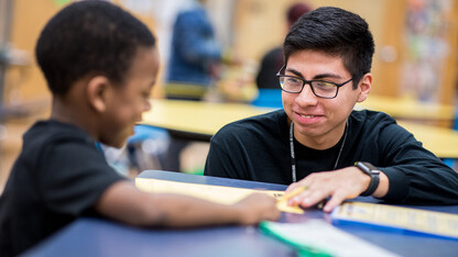 Nebraska's Carlos Ortega works with a student at the Community Learning Center at Lincoln's McPhee Elementary School.