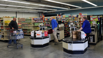 A male customer prepares to check out at a grocery store.