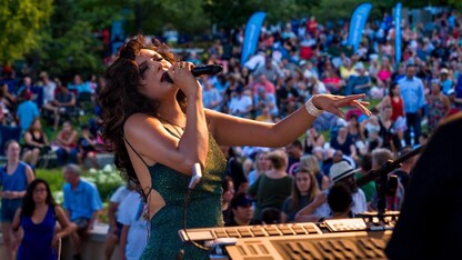 Alexis Arai sings into a microphone.