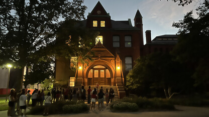 A group of students gathers at Architecture Hall to learn some of the history of the oldest building on campus.