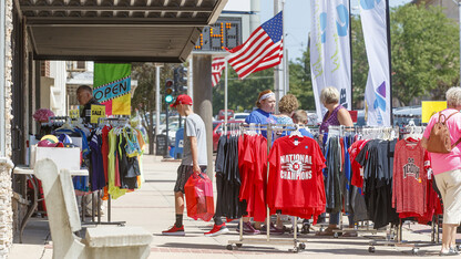 Shoppers look through T-shirts at a sidewalk sale in downtown McCook.