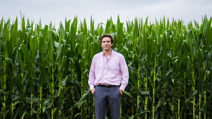 Patricio Grassini, associate professor of agronomy and horticulture at Nebraska, stands in front of a corn field.