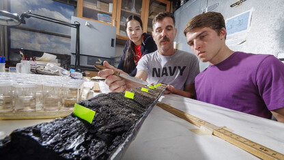 Doctoral student Jim Benes and UCARE students Jasmine Pham and Joe Stalder pose with charcoal samples from the Nebraska Sandhills.