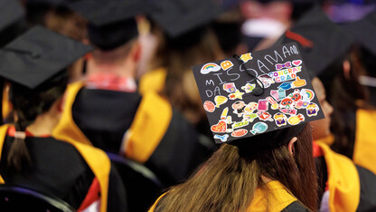 Amanda Ottersberg of Lincoln wears a mortar board designed by her preschool students during the graduate and professional degree ceremony Dec. 20 at Pinnacle Bank Arena.