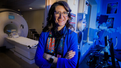 Maital Neta, professor of psychology, poses for a portrait in the Center for Brain, Biology and Behavior's MRI room.