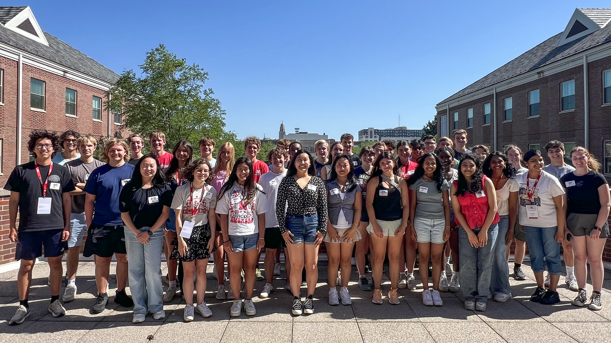 Thirty-nine college students — all members of the Jeffrey S. Raikes School of Computer Science and Management — pose for a photograph on the rooftop of the Kauffman Academic Residential Center on a clear day.