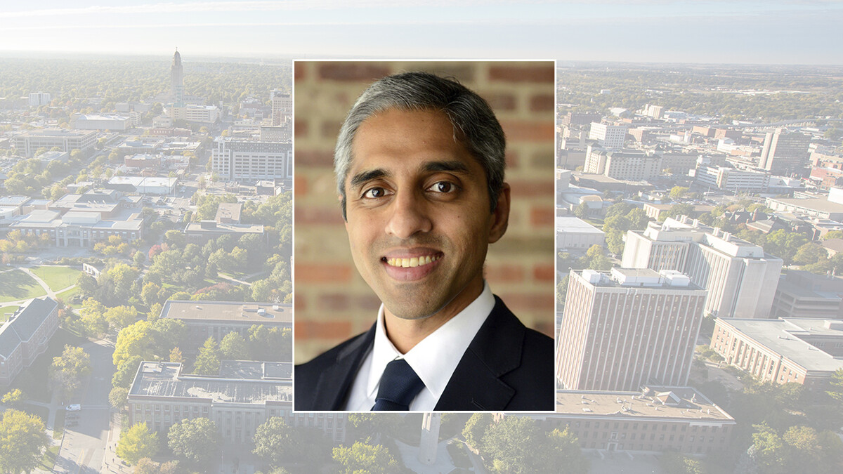 Color portrait of Dr. Vivek Murthy, former U.S. surgeon general, on a color campus background.