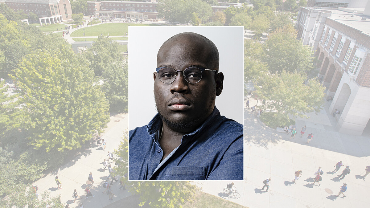 Color portrait of journalist and author Caleb Gayle on a color campus background.