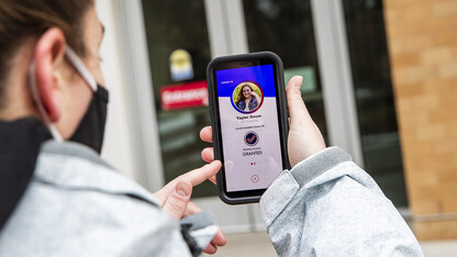 Taylor Daum demonstrates the Safer Community app, which will be used as part of the university's COVID-19 testing plans in the spring semester. Screen is simulated and may change slightly when the app is finalized.