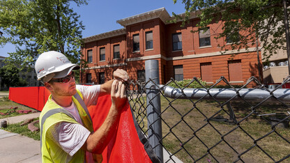 Miller Hall on East Campus is wrapped in construction fencing as the building will be demolished in the next few weeks.