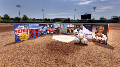 University of Nebraska Press books about baseball sitting around home plate at Haymarket Park.