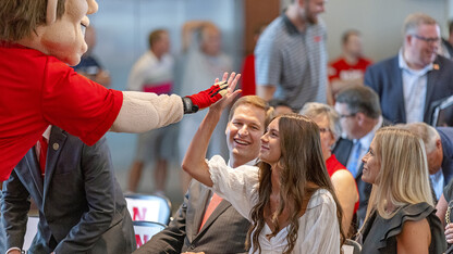 Herbie Husker gives a high five to Breanna Alberts, youngest daughter of Trev and Angie Alberts. Trev Alberts was announced as the university’s next athletic director on July 14.