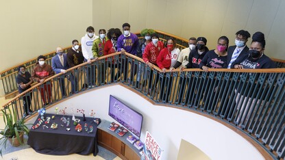 Students in the university's Divine Nine Greek organizations pose on the Gaughan Center steps wearing their organization letters.