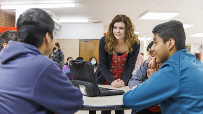 School psychologist Katie Bevins (center) talks with students in the commons area of Crete Middle School.