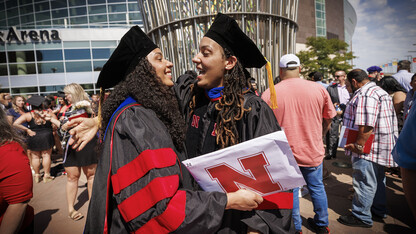 Megan Cardwell (left) hugs her twin sister, Marissa Oliver, after the summer 2022 commencement ceremony on Aug. 13.