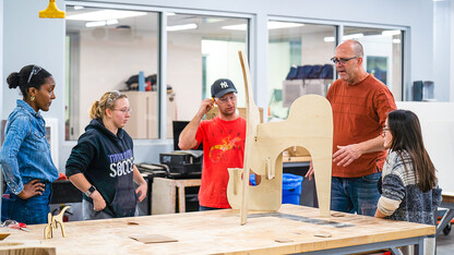 Aziza Cyamani, Elizabeth Loftus, Thomas Gerees, Iowa State Professor Chis Martin, and Caroline Gomel look over their almost finished project.