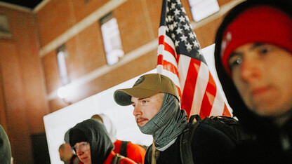 Cohan Bonow, senior in management and a Naval ROTC midshipman, stands with fellow marchers before the start of the marching.