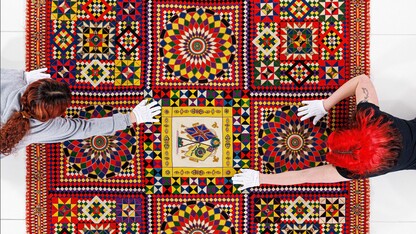 quilt museum employees prepping a quilt