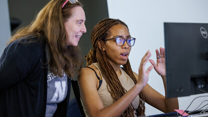 Laura Weakly (left), metadata encoding specialist, works with a student in the Digital Legal Research Lab. 