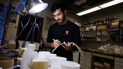 Abdallah Abdallah, an incoming UNL freshman from Lincoln, documents a spider’s activity while working in Eileen Hebets lab.