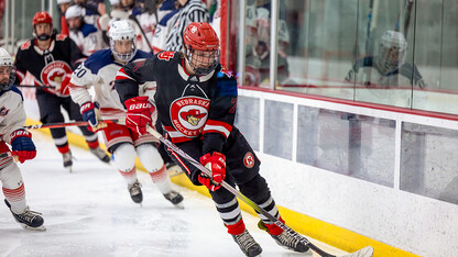 Dylan Mcrae, forward (74), moves the puck down the ice. 