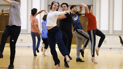 Grace Thomsen and Calen Bernbeck do a quick step dance with the rest of the gold group.