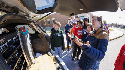 Charles Kropiewnicki, a graduate student in geosciences, explains the computers and technology carried by the TORUS storm chasing vehicles.