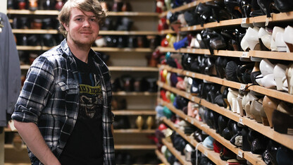 Hunter Rock stands in a costume closet behind the scenes of Nebraska Rep's "Big Fish."