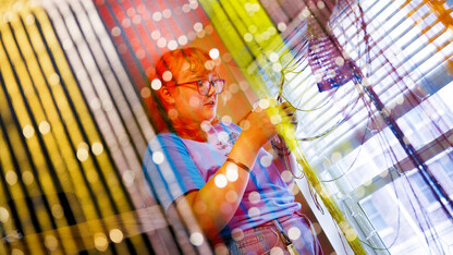 Eden Wilder untangles lights from a multi-colored screen in her campus residence hall room after moving in on Aug. 18.