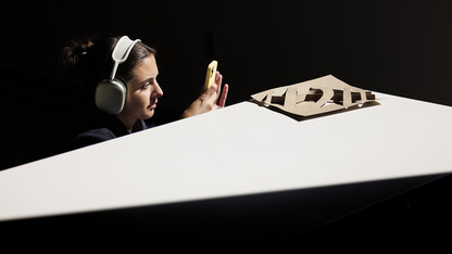 Kayla Edwards, a third-year architecture student from Papillion, uses sunlight streaming through windows in the College of Architecture addition to photograph a model.