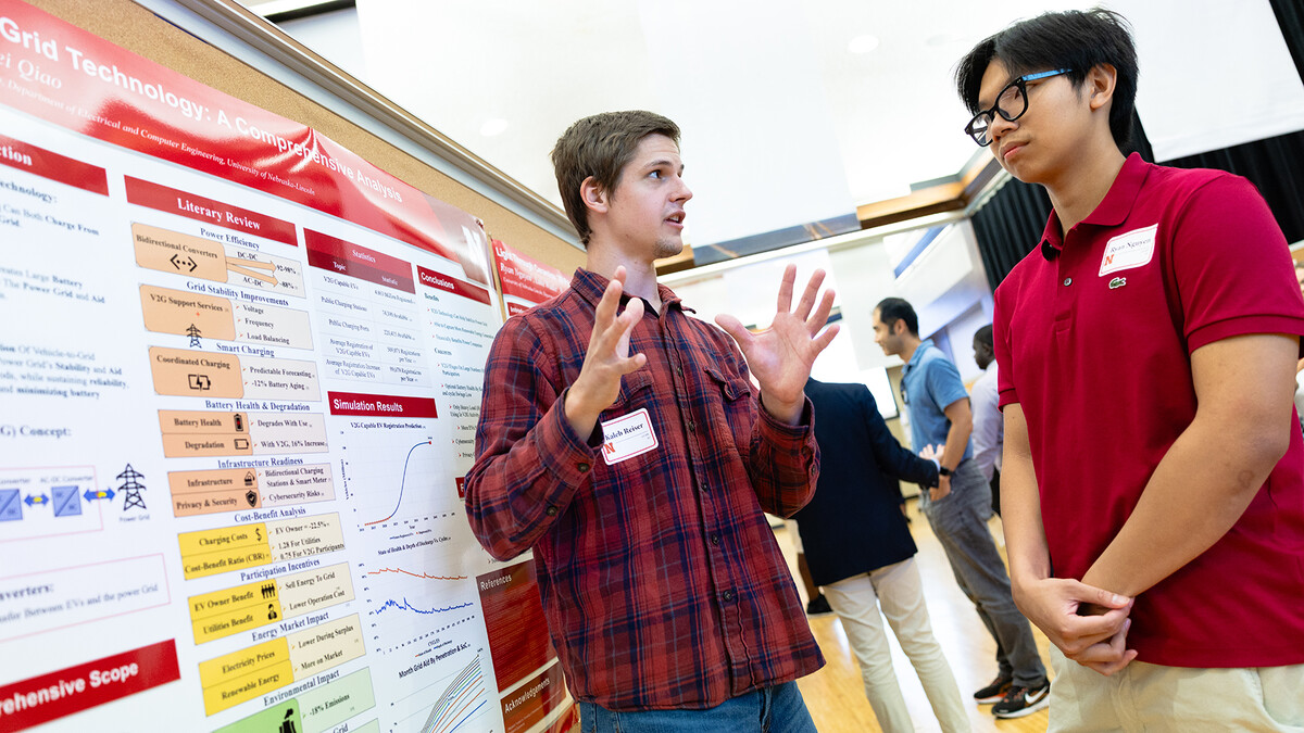 Kaleb Reiser, a senior studying electrical engineering, shares his summer research results with Ryan Nguyen, a junior studying mechanical engineering. Both students participated in the 10-week Summer Research Program and presented posters next to each other during a symposium held Tuesday, Aug. 5.