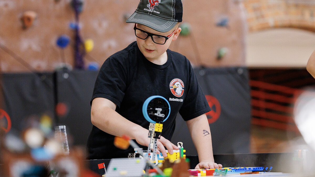 A competitor runs a practice robot match in the Coliseum. 