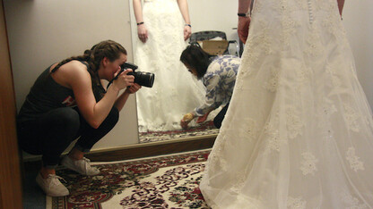 Alanna Johnson photographs May Nguyen as she works on a customer's wedding dress in her shop, May's Alterations. The photos were for the Nebraska Mosaic project.