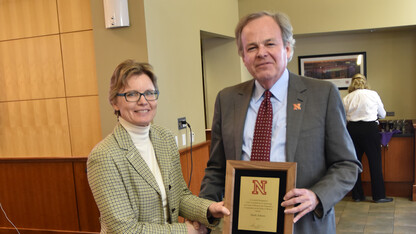 Mark Askren (right) poses with Susan Foster, director of institutional equity and compliance, after the presentation of the Outstanding Contribution to the Status of Women Award on March 17.