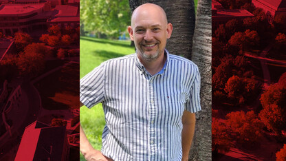 Photo of Jason Alsup standing outdoors by a tree.