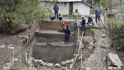 Members of an excavation team work in Assam State in northeastern India.