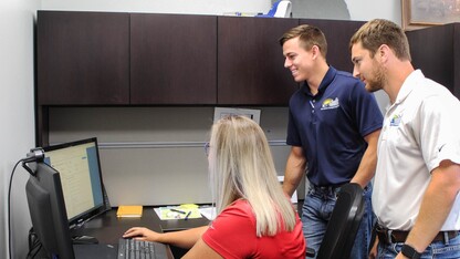 Bennett Perlinger (center) engages with his co-workers.