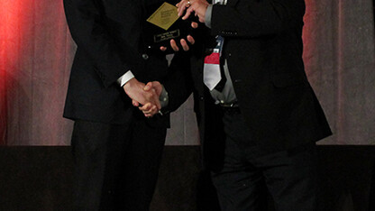 Bin Yang (left) receives a Gold Award from Orlando Auciello, president of the Materials Research Society.