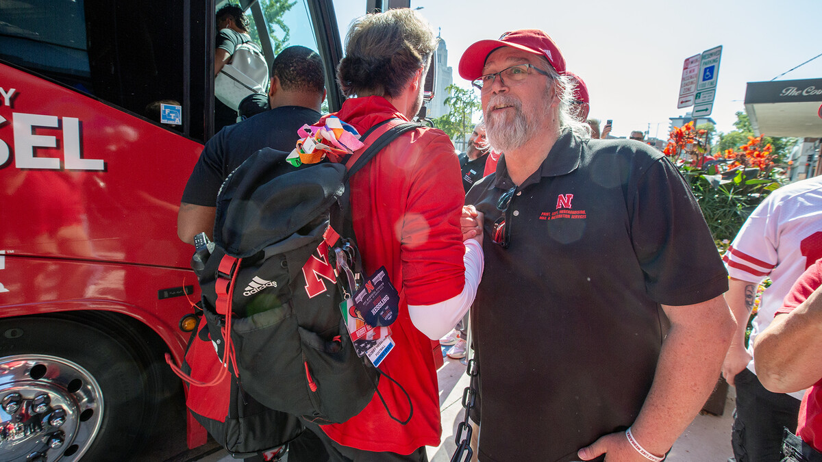 Mike Case wishes a member of the Husker football team well outside the Cornhusker Hotel before the Michigan State football game.