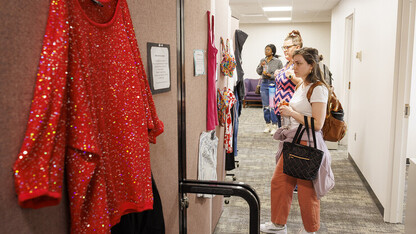 Graduate students Elyxcus Anaya and Jessica Boyles examine the "What Were You Wearing?" survivor art installation in April 2022. Photo by Craig Chandler, UCOMM.